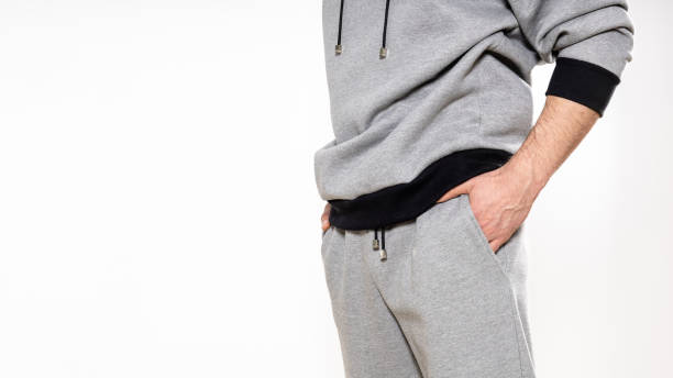 istock man in a gray tracksuit on a white background, copy space 1316675961