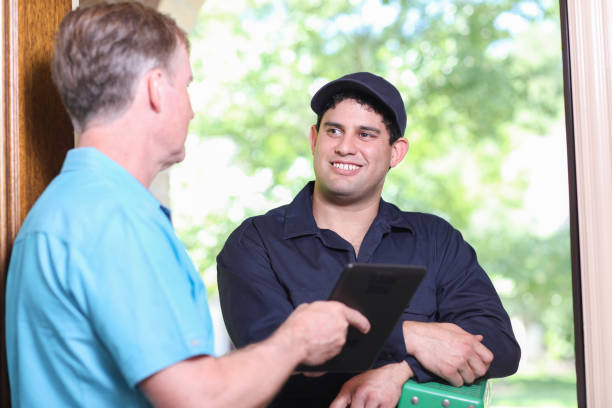 istock Latin descent repairman, technician makes house call at customer home. 1316678565