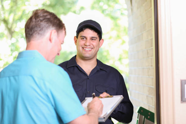 Latin descent repairman, technician makes house call at customer home.