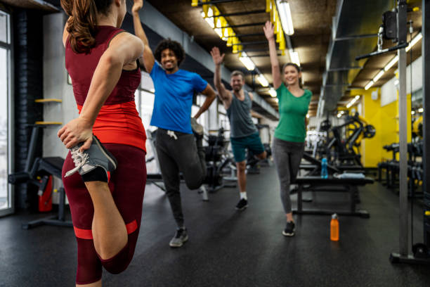 istock Group of young people doing exercises in gym 1316679176