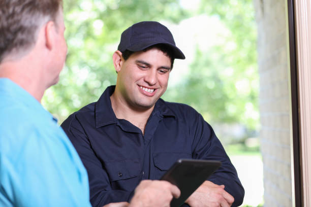 istock Latin descent repairman, technician makes house call at customer home. 1316679521