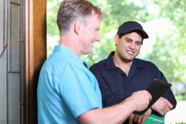 istock Latin descent repairman, technician makes house call at customer home. 1316679525