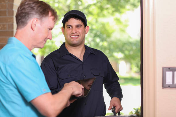 istock Latin descent repairman, technician makes house call at customer home. 1316679568