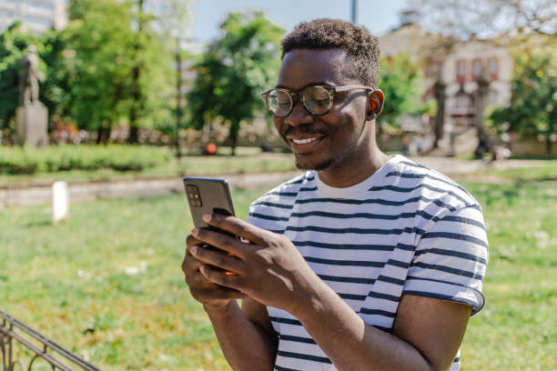istock African-American young man is using mobile phone in the park 1316681639