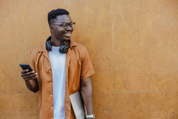 istock Portrait of confident young African-American using mobile phone 1316681978