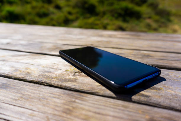 istock Smartphone leaning on a wooden table 1316682617