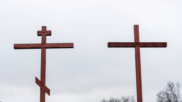 istock Orthodox and Catholic crosses side by side on dramatic sky background. The concept of unity of faith. Space for text. 1316682654