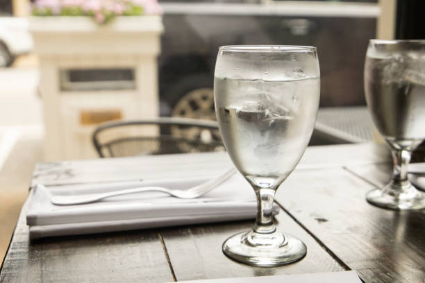 istock A water glass and a silverware setting on a wood table at a high end restaurant 1316683529