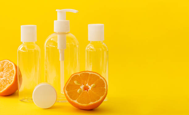 istock Plastic transparent cosmetic bottles with white cap and lemons on yellow background. 1316683676