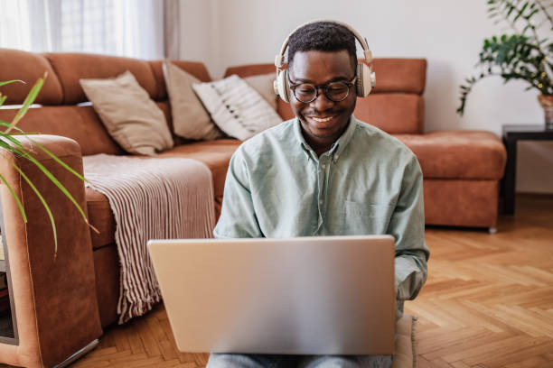 istock Young man using laptop at home 1316684198