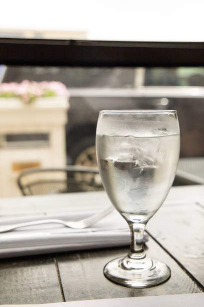 istock A water glass and a silverware setting on a wood table at a high end restaurant 1316685232