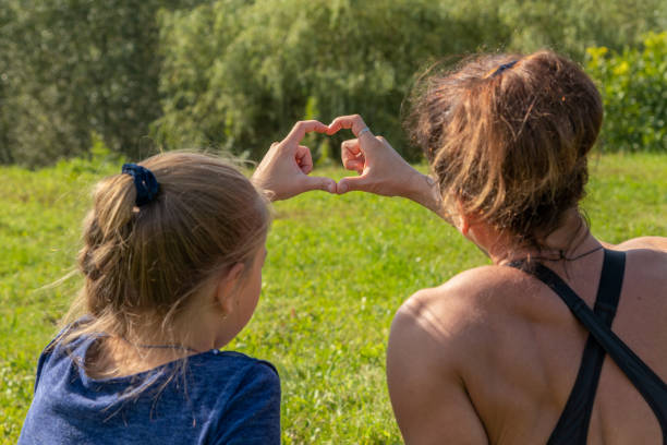 istock Mother and daughter make heart symbol 1316685960