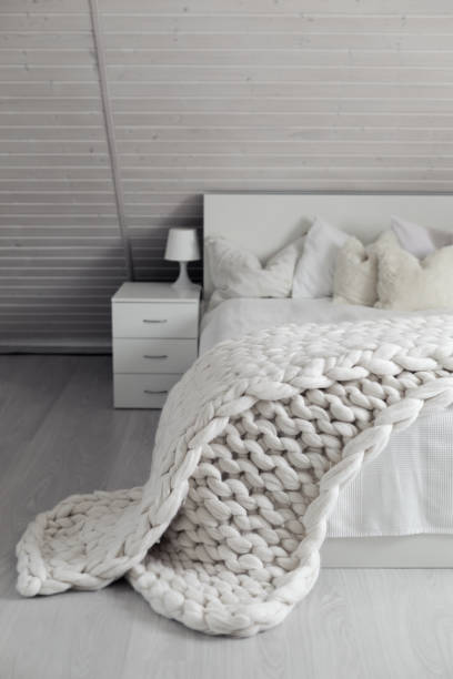 istock White nordic bedroom interior with knit plaid 1316689029