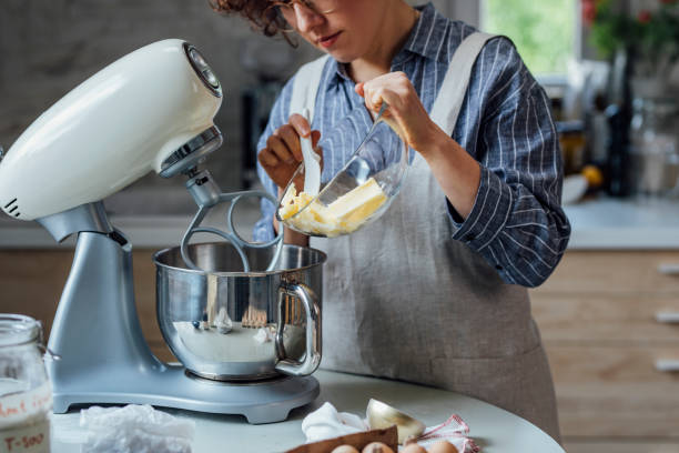 istock Woman Adding Butter to the Mixing Bowl 1316690037