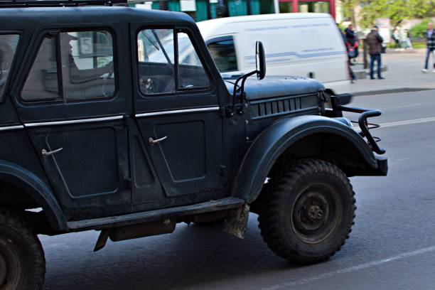 old suv on a city street - car individuality military 4x4 imagens e fotografias de stock