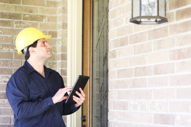 istock Latin descent man inspects home exterior. 1316691390
