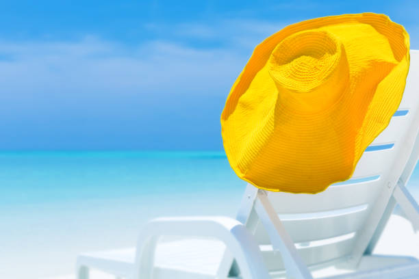 istock Straw yellow sunhat on chaise lounges 1316693843