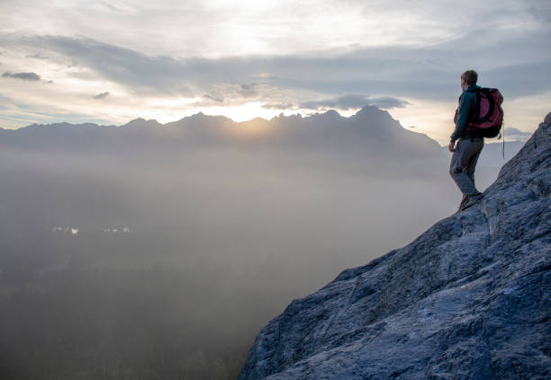 istock Hiker relaxes on mountain ridge at sunrise 1316695018