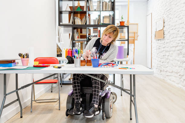 istock disabled woman in a wheelchair learning to paint 1316695849