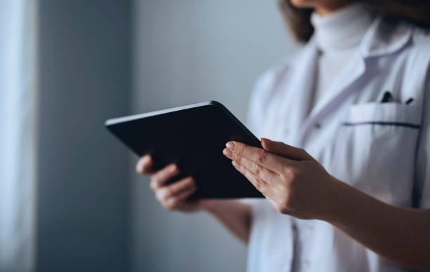 istock Female Doctor Holding Tablet in Hands 1316697386