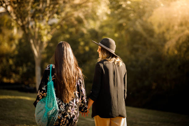istock Young female couple walking at public park 1316701437