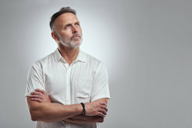 istock Studio shot of a mature man looking thoughtful against a grey background 1316702310