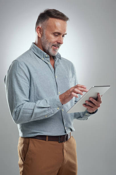 istock Studio shot of a mature man using a digital tablet against a grey background 1316703125