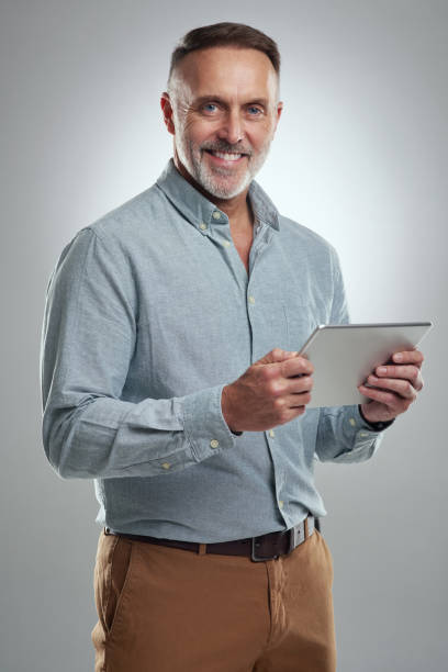 istock Studio portrait of a mature man using a digital tablet against a grey background 1316703126