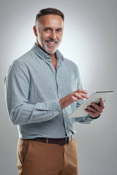 istock Studio portrait of a mature man using a digital tablet against a grey background 1316703136