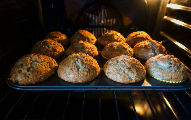 istock Baked muffins in a muffin pan on a rack in an oven 1316703282