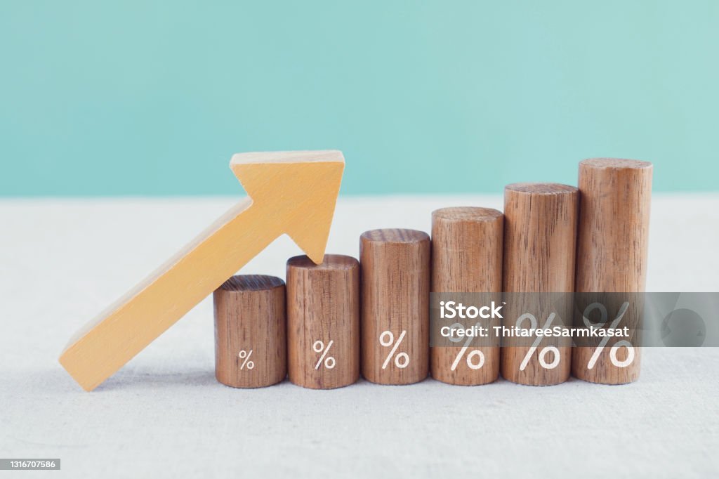 Wooden blocks with percentage sign and arrow up, financial growth, interest rate and mortgage rate increase, inflation concept Interest Rate Stock Photo