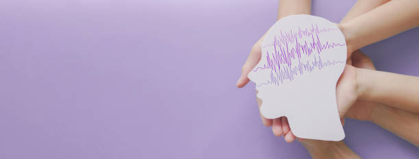 Adult and child hands holding encephalography brain paper cutout, autism, Epilepsy awareness, seizure disorder, stroke, alzheimer, mental health concept Adult and child hands holding encephalography brain paper cutout, autism, Epilepsy awareness, seizure disorder, stroke, alzheimer, mental health concept epilepsy stock pictures, royalty-free photos & images