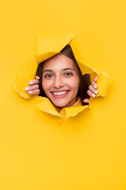 istock Young brunette tearing yellow paper 1316709670