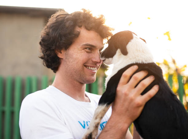 istock Happy volunteer playing with homeless dog 1316709715