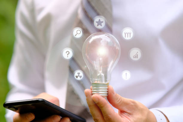istock Businessman hand holding light bulb and business solutions 1316711261