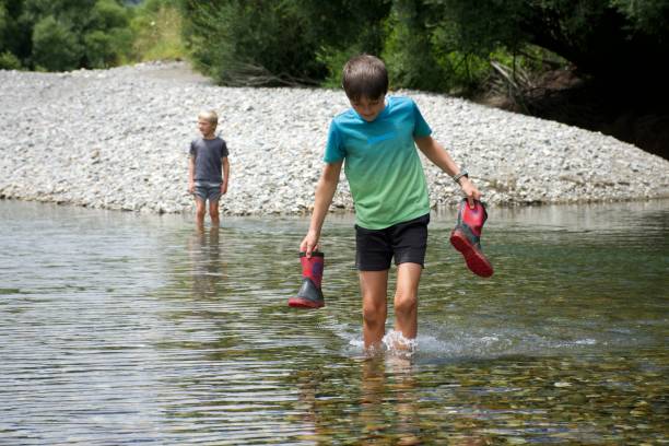 istock Children Paddling in River 1316714395