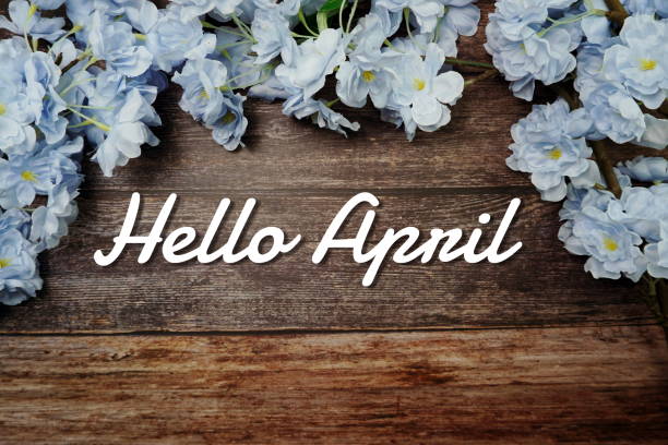 istock Hello April text and spring flower decoration on wooden background 1316718472