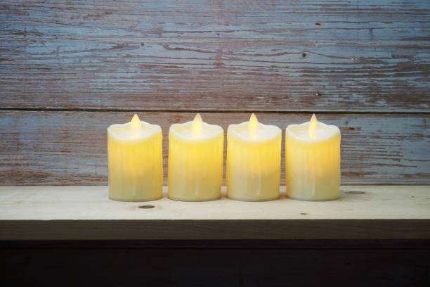 istock LED Candle Light electronic with space copy on wooden background 1316718557