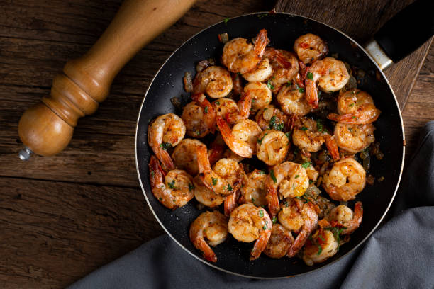 istock Delicious grilled prawns on wooden background. 1316718708