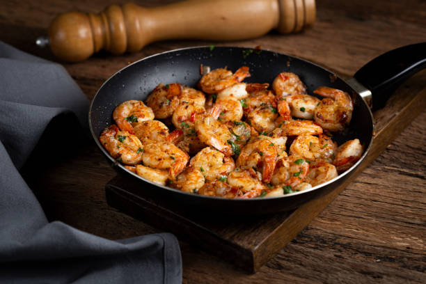 istock Delicious grilled prawns on wooden background. 1316718716