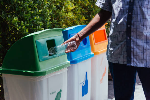 istock black hand throwing an empty plastic water bottle in the recycling garbage trash 1316721486