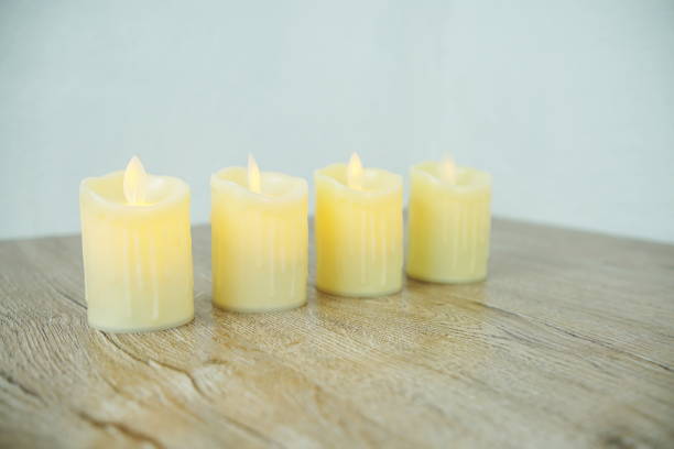 istock LED Candle Light electronic with space copy on wooden background 1316725665