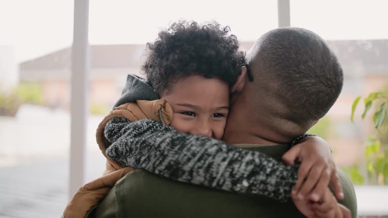 4k video footage of an adorable little boy hugging his father at home