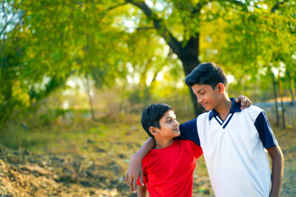 istock two little indian brother walking on road 1316728133