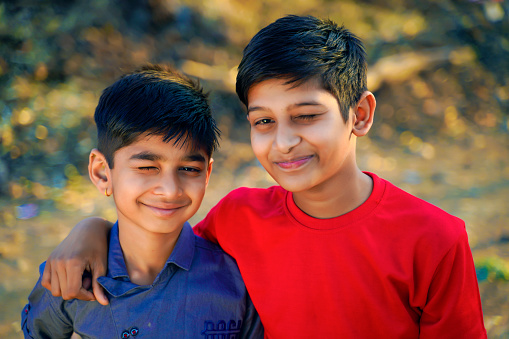 two young indian child wink his eye