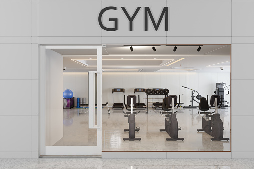 Facade Of Fitness Club Entrance With Treadmill, Fitness Ball And Other Exercise Equipments
