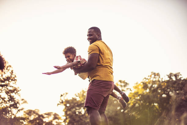 istock African American father and son having fun in nature. 1316731136