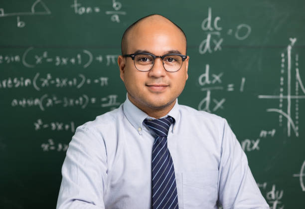istock Indian young teacher man looking at camera sitting teaching online video conference live stream. Asian teacher teaching class webinar online for students learning. 1316731532