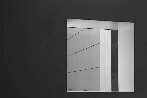 istock A dark grey wall with a window leading to a white wall with diagonal lines, modern building  with clear and structured elements - copy-space 1316734057