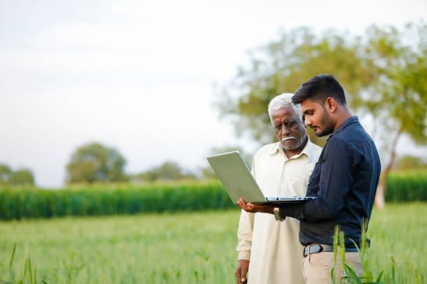 istock young indian agronomist with farmer at field 1316735225
